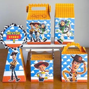 May include: A collection of Toy Story-themed party favors. The set includes various boxes and a cone-shaped decoration, all featuring characters like Woody, Buzz Lightyear, and Jessie. The designs incorporate blue skies, clouds, and orange accents.