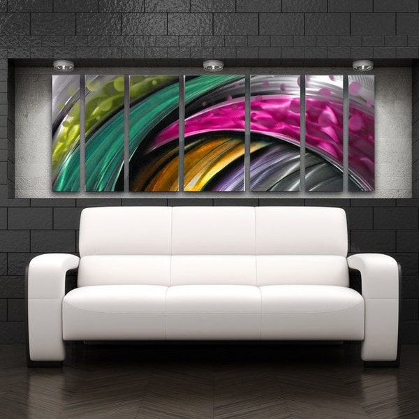 May include: A multi-panelled abstract metal artwork with a swirling design in shades of green, yellow, pink, and silver. The artwork is displayed above a white leather sofa in a contemporary living room setting.