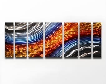 May include: Abstract metal wall art with a multi-panel design. The panels feature a flowing, wave-like pattern in shades of blue, silver, and orange.