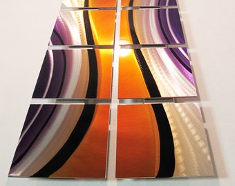 May include: A wall art piece made of metal panels with a modern abstract design. The panels are arranged in a grid pattern and feature a combination of orange, purple, silver, and black colours.