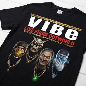 May include: Black t-shirt with the word "VIBE" in large white letters and the phrase "LIVE FROM OUTWORLD" in red. The shirt features images of four characters with gold chains and the text "NETHERREALM: NO ONE LEAVES ALIVE".
