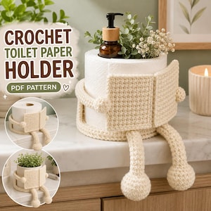 May include: A cream-coloured crochet toilet paper holder featuring a textured square front panel and two dangling legs with round feet. The holder wraps around a roll of white toilet paper, which contains a brown pump bottle and green foliage.