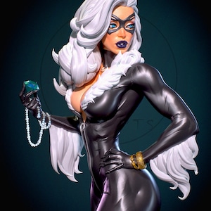 May include: A statue of a character in a black catsuit with white fur trim and gloves. The character has white hair, a black mask, and blue eyes. She holds a green gem and a pearl necklace, with gold bracelets on her wrist.