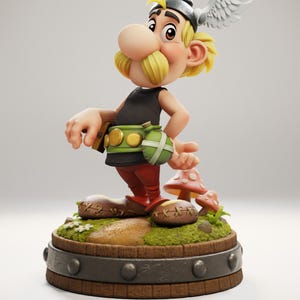 Op de afbeelding: Gedetailleerd beeldje van een stripfiguur met een grote neus en gele snor. Het figuur draagt een gevleugelde helm, een zwarte top, een rode broek en een groene riem met een zakje. Het staat op een houten voet met een paddenstoel.