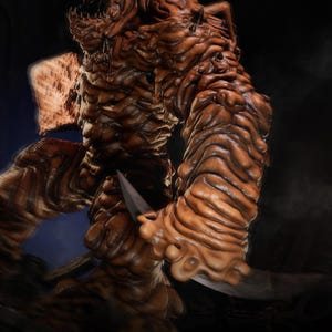 May include: A detailed, brown monster figure with a menacing expression, holding a silver blade. The figure has a textured, organic appearance. The image includes the text "PRESUPPORT READY 1-6 SCALE" and "AVAILABLE ON PATREON".