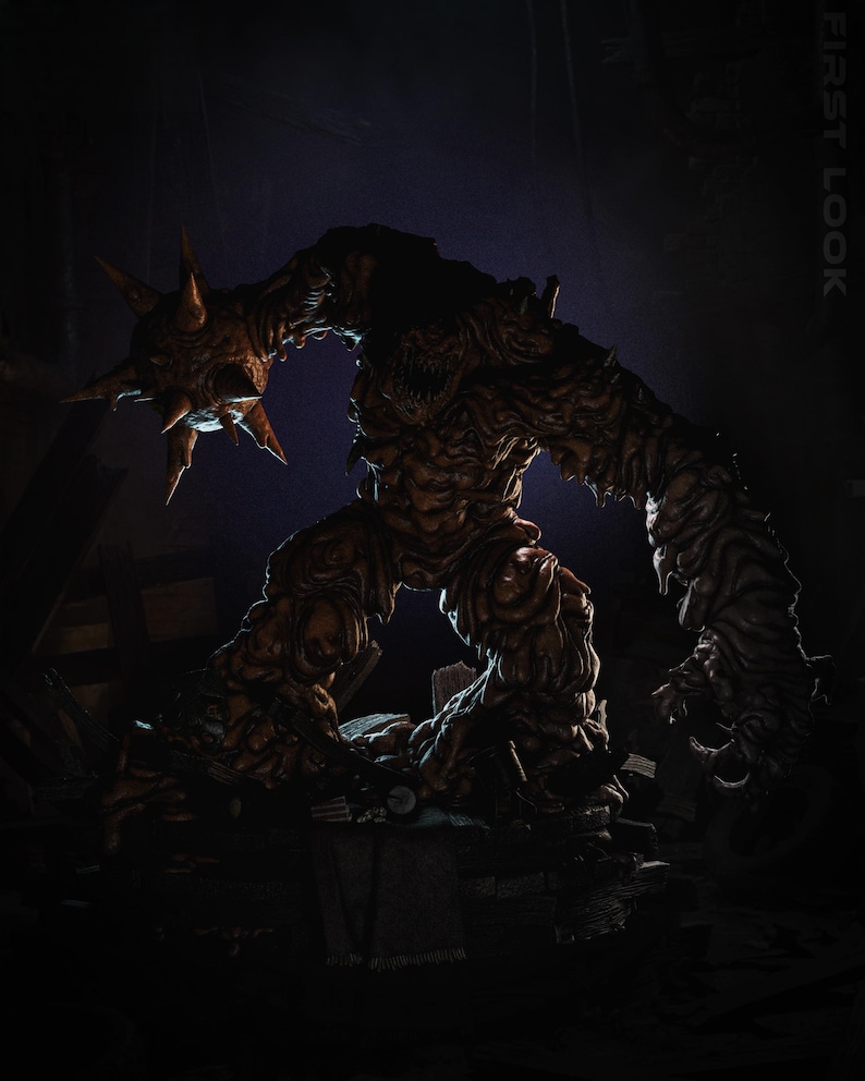 May include: A detailed, full-body image of a monstrous creature with a rough, textured, brown skin. The creature has a large, spiky head and a menacing expression. The image is dark, with the words "FIRST LOOK" in the upper right corner.