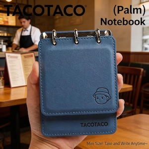 Może przedstawiać: Niebieski "(Palm) Notebook" ze srebrnymi metalowymi pierścieniami i marką "TACOTACO" wydrukowaną na okładce. Notatnik ma małą ilustrację z kreskówek i tekst "Mini Size! Take and Write Anytime~."