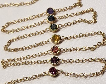 Necklace - Montana Sapphire .88 CTW 7 Rainbow Colored Rounds Bezel Mounted in 14K Yellow Gold