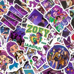 May include: A collection of assorted vinyl stickers featuring colorful anime-style characters, K-pop themes, and graphic designs. One prominent sticker displays the text ZOEY EST. 2025 HUNTRX with a central character illustration and heart motif.