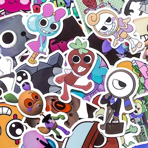 May include: A collection of colorful die-cut stickers featuring various cartoon characters, including a blue creature with a pink bow, a brown strawberry-shaped figure, and a character with a magnifying glass head holding a brown briefcase.
