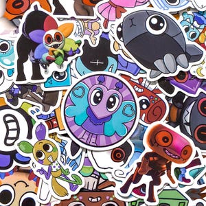 May include: A collection of assorted vinyl stickers featuring various cartoon characters and creatures. The designs include a central circular purple heart-shaped character, a multi-colored flower creature, a grey robotic figure, and a yellow insect-like being.