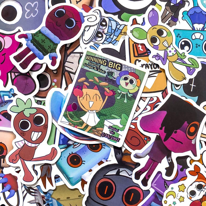 May include: A collection of colorful cartoon stickers featuring various characters, including a central rectangular sticker titled WINNING BIG Starring Scraps & Vee with the date 3/19/1997, surrounded by diverse animated figures in various poses.