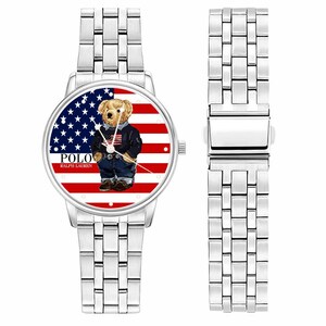 May include: A silver wristwatch with a round face featuring a bear wearing a jacket and jeans against a backdrop of the American flag. The watch face displays the text "POLO RALPH LAUREN". The watch has a silver band.