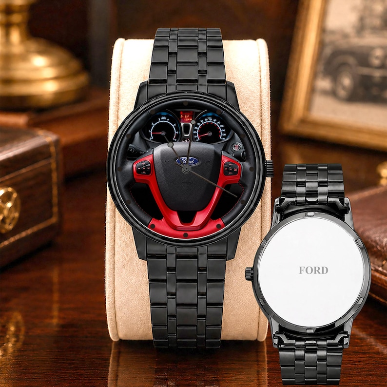 May include: Black wristwatch featuring a dial with a steering wheel design, including red accents and the Ford logo. The watch has a black metal band and a white watch face with the word "FORD".
