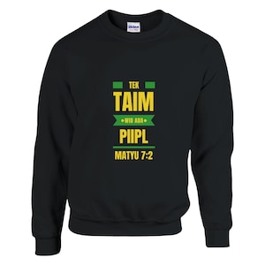 May include: Black crewneck sweatshirt with the text "TEK TAIM WID ADA PIIPL MATYU 7:2" in yellow and green. The sweatshirt is made of a soft material and has a ribbed collar, cuffs, and hem.