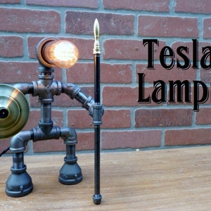 Robot iron pipe lamp, warrior design, brass shield and spear tip, on/off switch in center of shield, cloth cord, includes bulb!