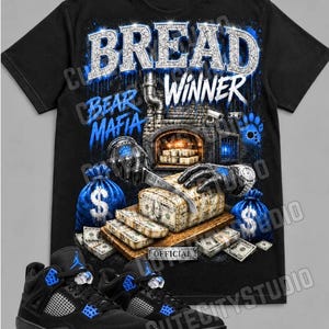 May include: A black short-sleeve t-shirt featuring a graphic print with the text BREAD WINNER and BEAR MAFIA. The design shows a brick oven, stacks of cash, blue money bags, and gloved hands. Below the shirt are black and blue athletic sneakers.