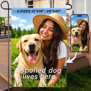 May include: A garden flag with the text "A spoiled dog lives here." The flag features a photo of a woman and a yellow Labrador Retriever. The flag is available in two sizes: 12"x18" and 28"x40".