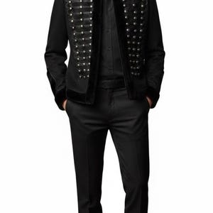 May include: A black military-style jacket with silver button details and a faux fur collar. The jacket is paired with a black button-down shirt and black dress pants. The outfit is completed with black dress shoes.