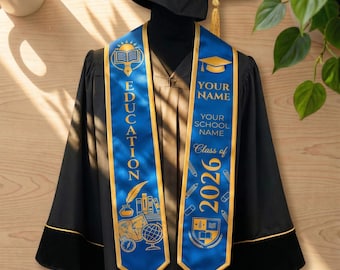 May include: A black graduation gown with gold trim and a matching mortarboard. A blue and gold sash displays the word "EDUCATION" and the text "YOUR NAME", "YOUR SCHOOL NAME", and "Class of 2026". The sash features academic icons.