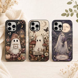 May include: Three phone cases featuring ghost illustrations. The first shows a ghost with a mug labeled Emma, the second a ghost with a sign labeled Willow, and the third a ghost holding flowers with a nameplate labeled Luna, all with floral motifs.