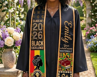 May include: A black graduation gown with a custom sash. The sash features the text "Class of 2026" and "Black Excellence". The sash also includes the name "Emily" and "Your school name MASTERED IT". The sash has a colorful design.