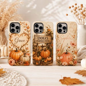 May include: Three phone cases featuring autumn themes. The first shows a heart-shaped vine with the name Grace and pumpkins. The second displays a wooden sign reading EMMA'S PUMPKIN PATCH with pumpkins. The third features the name Sophia and flowers.