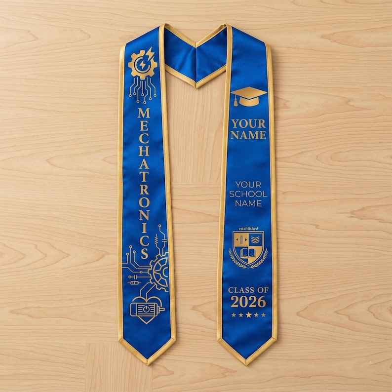 May include: A blue and gold graduation sash with the word "MECHATRONICS" printed vertically. The sash has a gold trim and features a graduation cap graphic, the text "YOUR NAME", "YOUR SCHOOL NAME", and "CLASS OF 2026".
