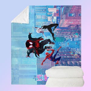 May include: A plush, white sherpa blanket featuring a vibrant illustration of Spider-Man characters in action against a cityscape backdrop. The blanket showcases Spider-Man, Spider-Gwen, and Miles Morales in dynamic poses, with a soft, white sherpa backing.