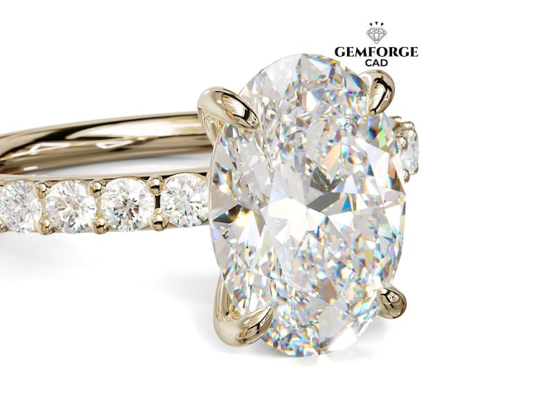 May include: A gold ring with a large, oval-cut diamond as the focal point. The band is embellished with smaller diamonds. The ring is displayed against a white backdrop, emphasizing its sparkle. The Gemforge CAD logo is visible in the top right corner.