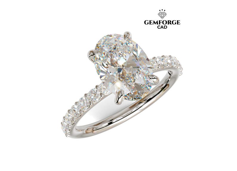 May include: A diamond engagement ring featuring an oval-cut central stone. The white metal band is set with smaller diamonds. The ring is displayed against a white backdrop. The Gemforge CAD logo is visible in the top right corner.
