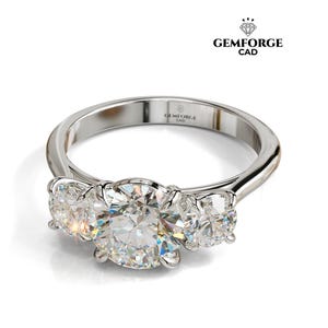 Puede incluir: Un anillo de compromiso de tres piedras con una banda de plata pulida. El anillo presenta una piedra central grande, redonda y clara flanqueada por dos piedras más pequeñas. El logotipo de Gemforge CAD es visible.