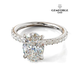 Puede incluir: Anillo de plata con un diamante central de talla ovalada, rodeado de diamantes más pequeños incrustados en la banda. El logotipo de Gemforge CAD es visible en la esquina superior derecha.