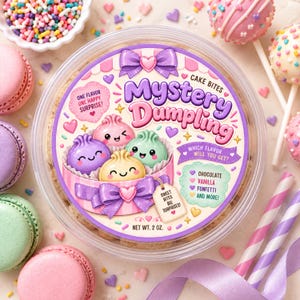 May include: A round clear plastic container of Mystery Dumpling cake bites with a label featuring purple, pink, green, and yellow cartoon dumplings, a purple bow, and text including "One flavor one happy surprise!" and "Net wt. 2 oz."