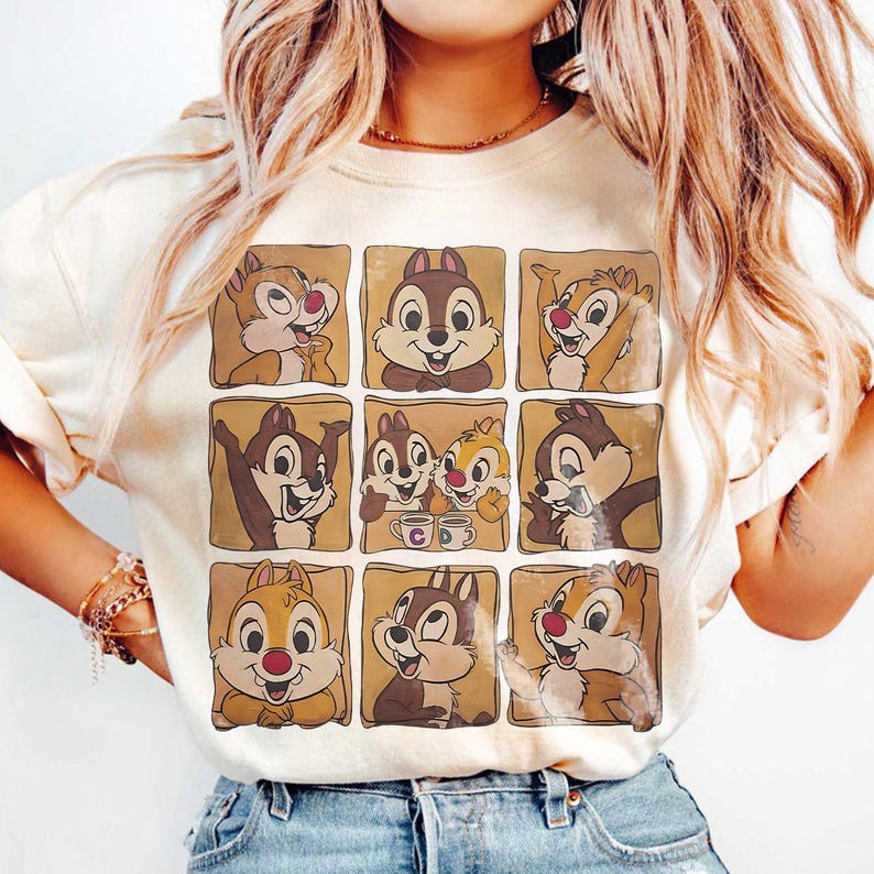 May include: Cream-colored sweatshirt featuring a grid of nine cartoon chipmunk images. Each chipmunk is in a different pose, set against a brown background. The chipmunks have brown and tan fur, with red noses and smiles.