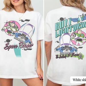 May include: A white t-shirt featuring a graphic of Buzz Lightyear and a spaceship. The front displays the text Space Ranger. The back features the text Buzz Lightyear and To Infinity & Beyond, along with a graphic of the character and a spaceship.