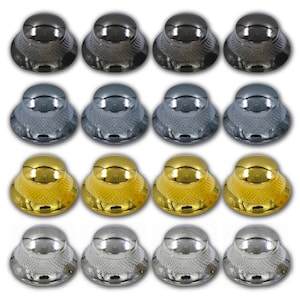 May include: An array of sixteen decorative cabinet knobs in four different metallic finishes: dark gray, silver, gold, and chrome. Each knob has a rounded top and a textured, scalloped base. The knobs are arranged in four rows of four.