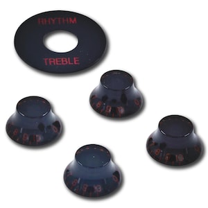 May include: A black circular rhythm and treble switch plate with red text and four matching black bell-shaped control knobs. Each knob features a translucent finish with red numerical markings ranging from zero to ten around the base.