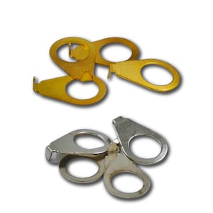 May include: Two sets of metal clasps. One set is gold-colored, and the other is silver-colored. Each clasp has two circular openings and a connecting piece. The clasps are designed to connect two pieces of material.