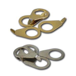May include: A collection of metal fasteners featuring a flat, teardrop-shaped design with a circular hole at the wider end and a small, pointed tab at the narrow end. The set includes several pieces in a polished gold tone and a silver tone finish.