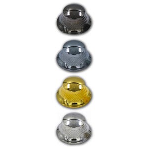 May include: Four metallic bottle stoppers in a row. The stoppers are in silver, gold, and dark gray colors. Each stopper has a rounded top and a textured, flared base. The stoppers are displayed against a white background.