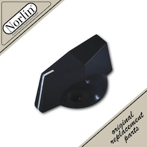 May include: A black plastic control knob with a wedge-shaped profile and a white indicator line on the side. The knob features a circular base and a tapered top edge. The image includes the Norlin logo and the text original replacement parts.