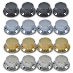 May include: A collection of sixteen cylindrical control knobs arranged in a four-by-four grid. The set includes four rows of knobs in distinct metallic finishes: matte black, polished chrome, brushed gold, and bright silver. Each knob features a textured, knurled side grip and a smooth, flat top surface.