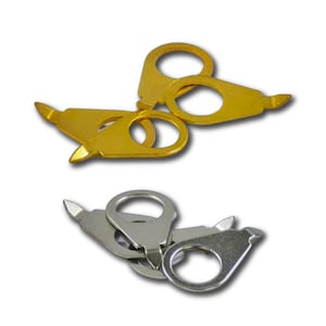 May include: A collection of gold and silver-colored metal clasps. Each clasp has a ring-shaped opening and a pointed end. The clasps are designed for jewelry making or crafts. The image shows several clasps in a close-up view.