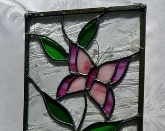 Vintage stained glass hanging window panel pink and lavender butterfly green leaves textured clear glass background