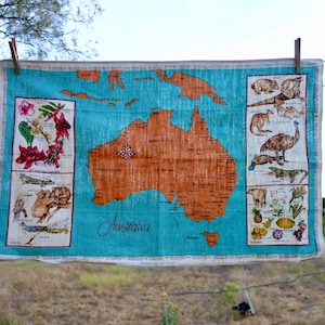 Aussie linen souvenir kitchen towel map of Australia and Tasmania blue background map flowers fauna produce latitude and longitude
