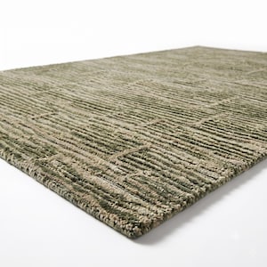 May include: A rectangular area rug featuring a textured, high-low pile construction. The surface displays a repeating geometric pattern of alternating vertical and horizontal lines in shades of sage green, olive, and neutral beige tones.