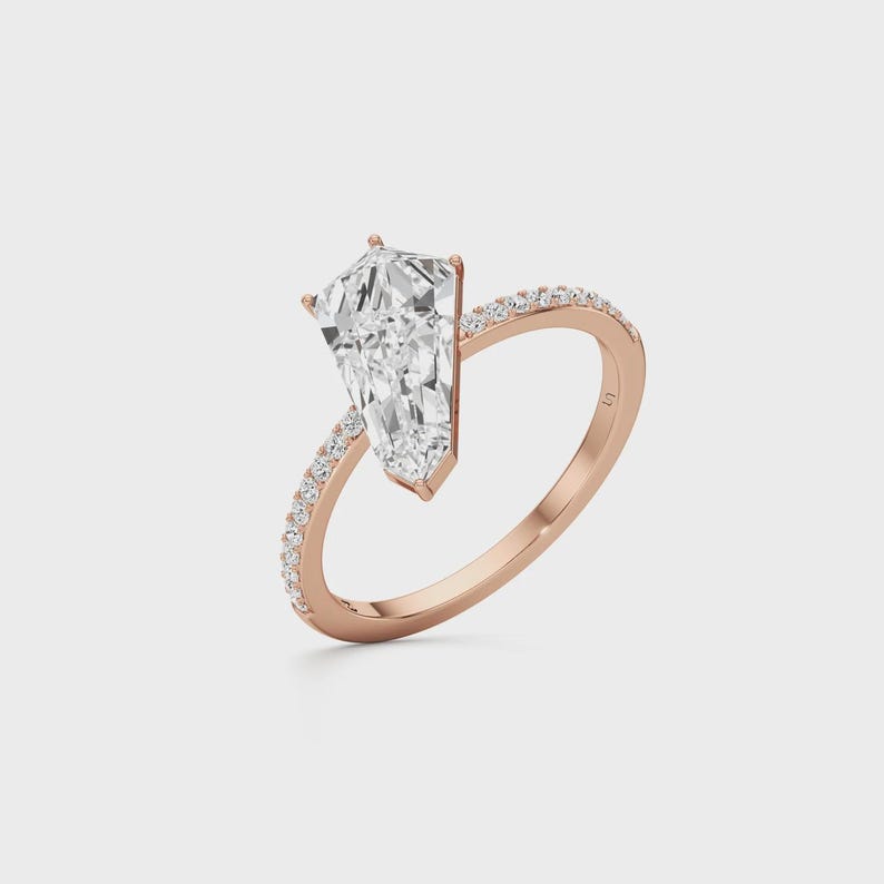 Modern kite shaped diamond ring with a delicate pavé setting in solid 14K gold