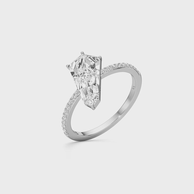 Minimalist kite cut solitaire engagement ring with sparkling accent diamonds on the band