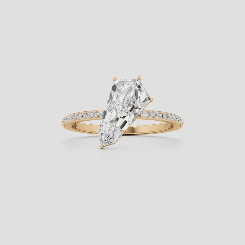 Kite cut diamond engagement ring in 14K yellow gold featuring a geometric solitaire design and pavé band